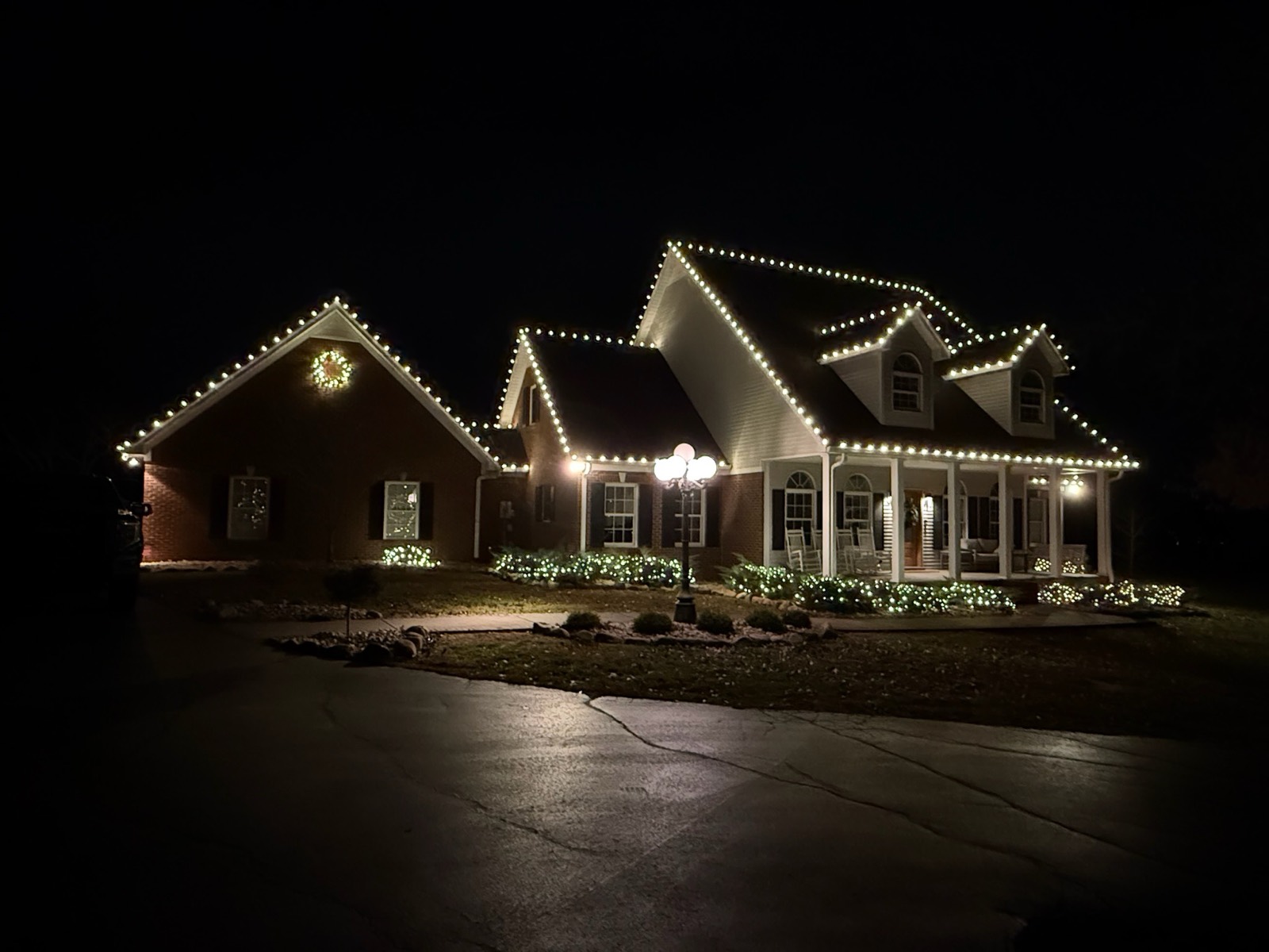 Warm white C9 roofline lighting on a brick home, alternate angle, Bowling Green KY